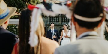 Couple laughing at a wedding with disguised guests