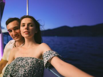 Portrait of happy couple on the yacht in the evening